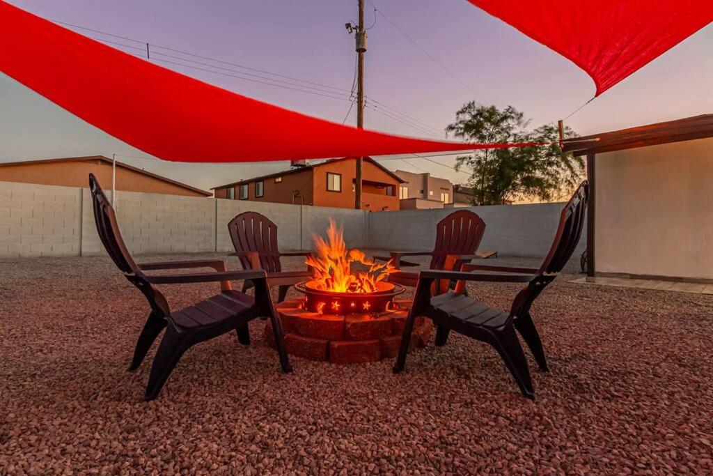 a fire pit with two chairs and a red umbrella at Phoenix Retreat - 1 Bedroom King Suite with 2 Smart TVs - 10 min from Airp - Unit B in Phoenix