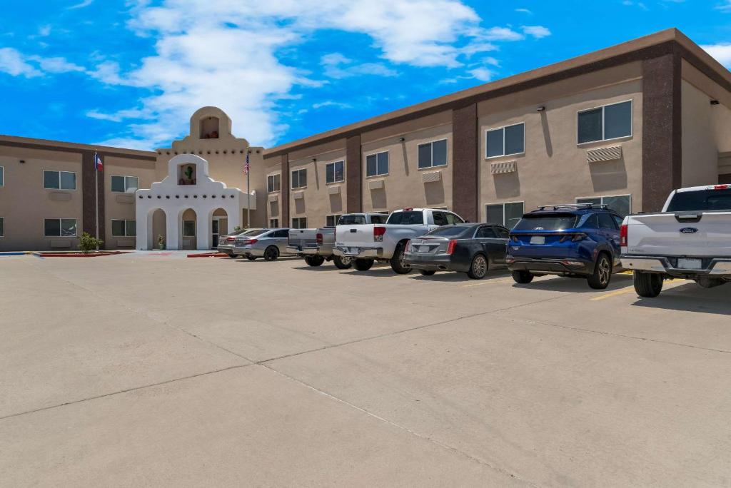 a parking lot in front of a building with cars parked at Quality Inn Alpine in Alpine