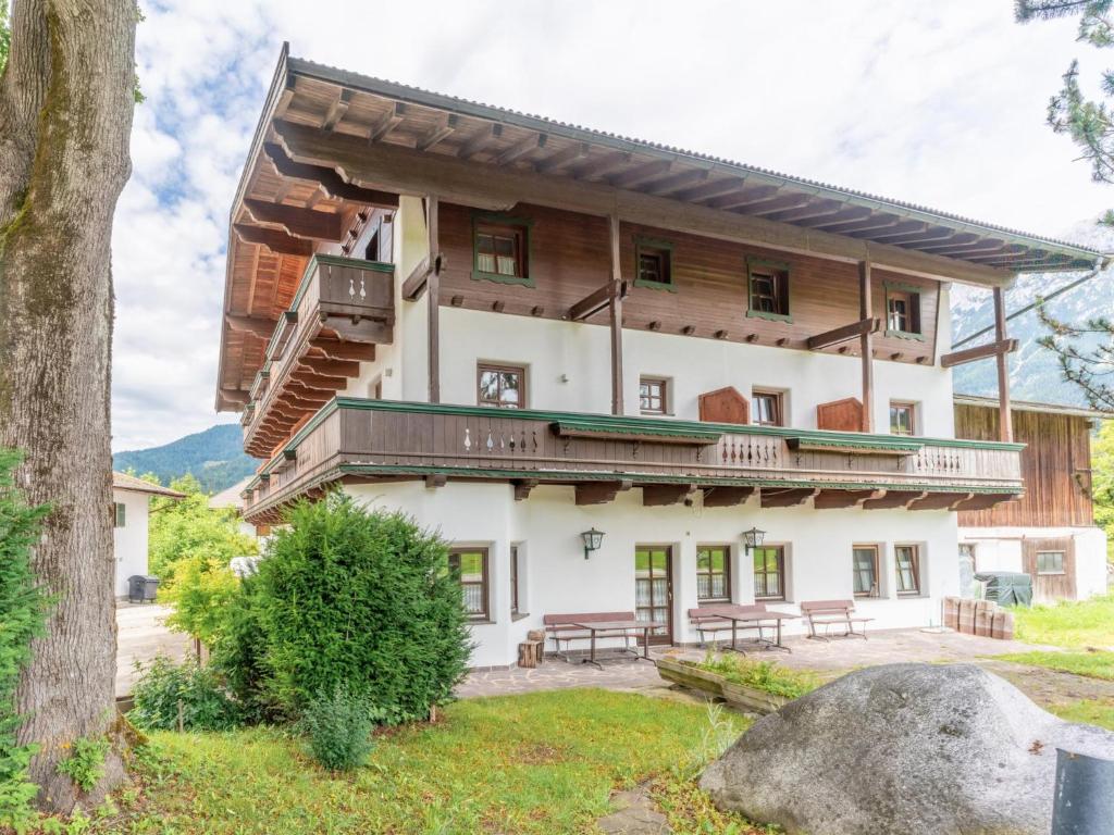 a large white building with a balcony at Pension Blaiken L in Scheffau am Wilden Kaiser