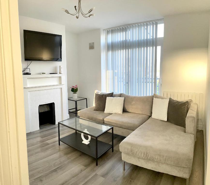 a living room with a couch and a fireplace at 2 bedroom apartment with balcony near Tottenham Hostpur Stadium in Edmonton