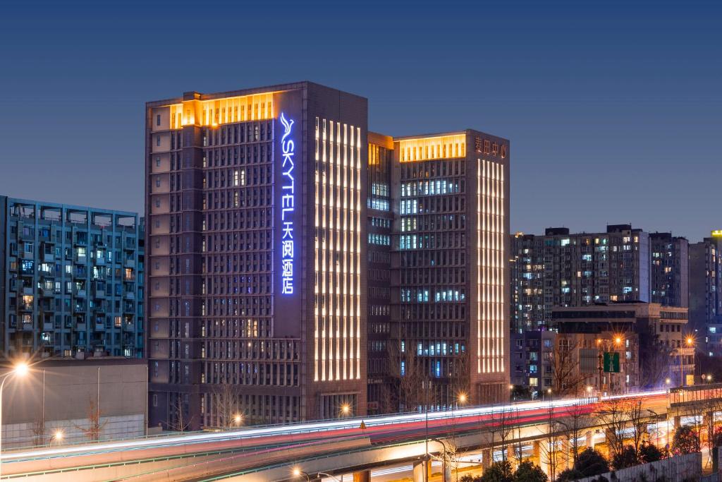 Skytel Hotel Chengdu-City Center في تشنغدو: مبنى طويل مع علامة على الجانب منه