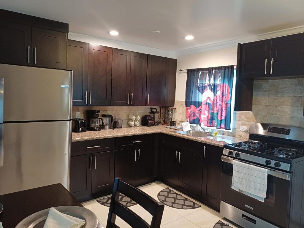 a kitchen with dark wood cabinets and a refrigerator at Da Bottom in Curtis