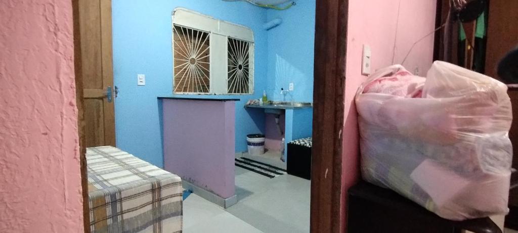 a room with a bed and a room with a mirror at Apartamento Acochegante in Manaus