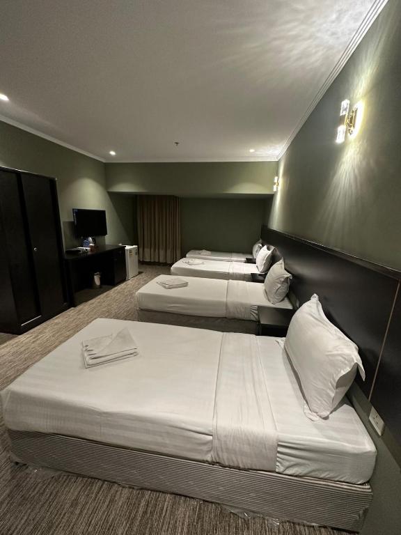 Postel nebo postele na pokoji v ubytování فندق كنان العزيزية Kinan Al Azizia Hotel Makkah