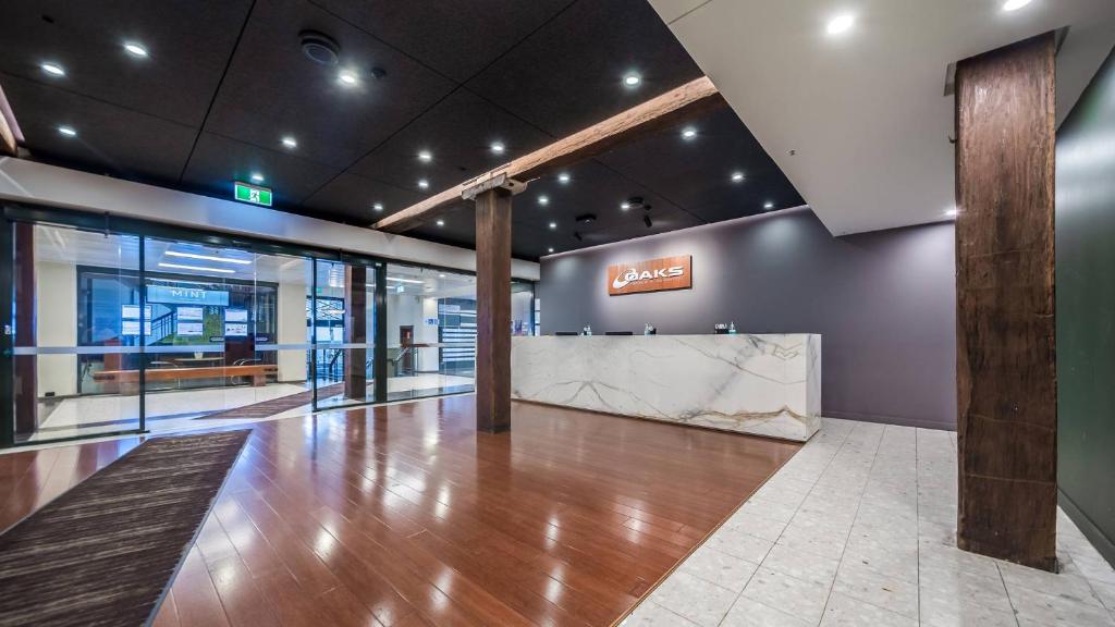 Una televisión o centro de entretenimiento en Oaks Sydney Goldsbrough Suites
