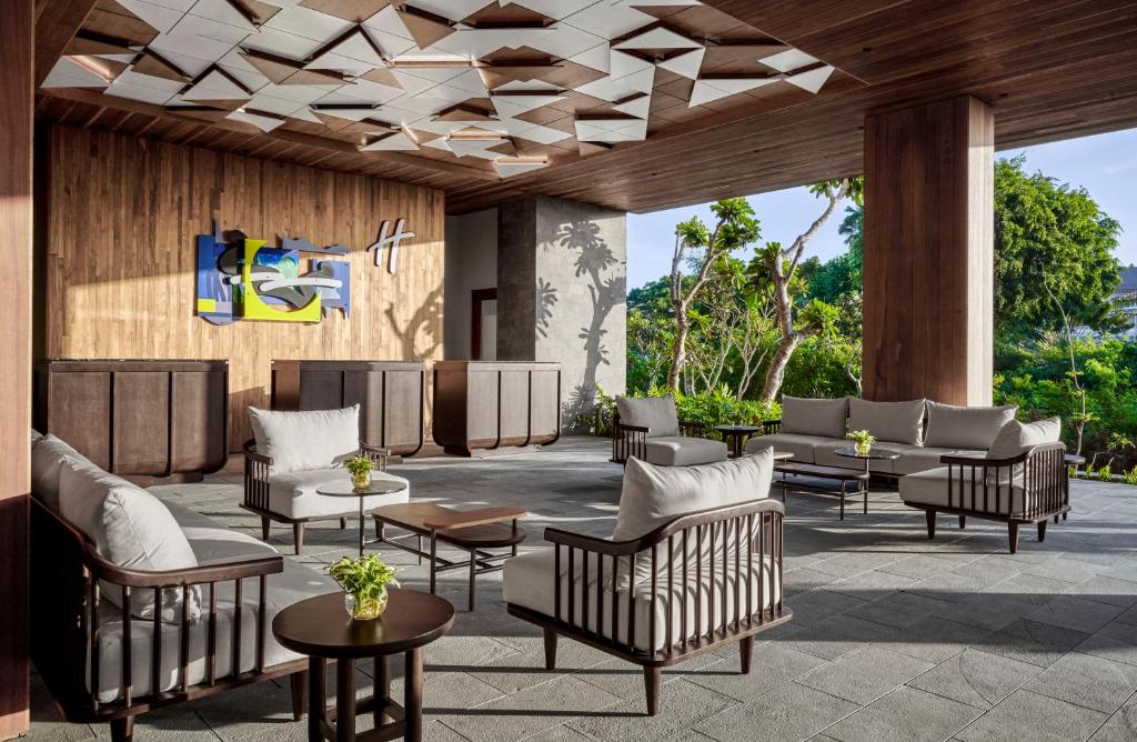 a lobby at the resort with couches and tables at Holiday Inn Resort Bali Canggu by IHG in Canggu