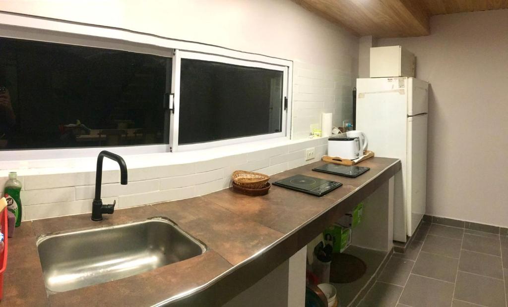 a kitchen with a sink and a large window at LOFT JUJUY, Alto Gorritti - Departamento cerca del Centro in San Salvador de Jujuy