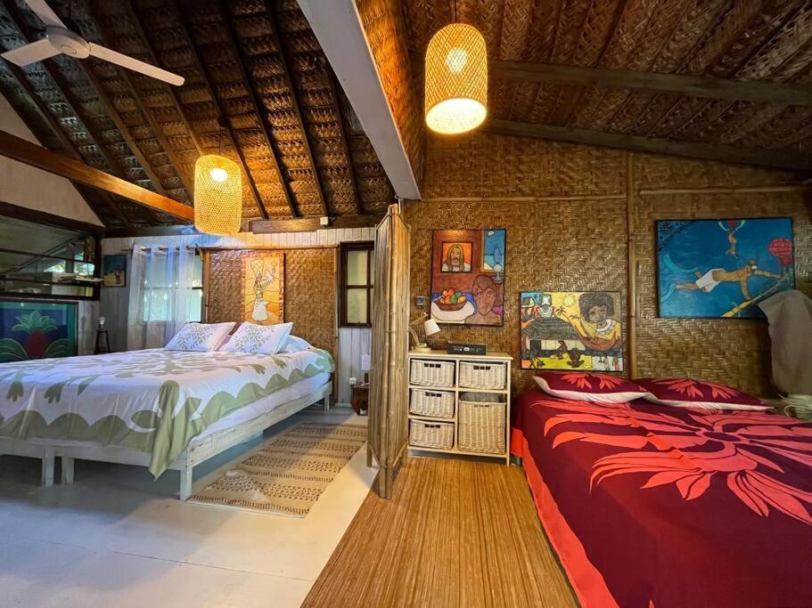 a bedroom with two beds in a room at Fare Kirihai in Teavaro