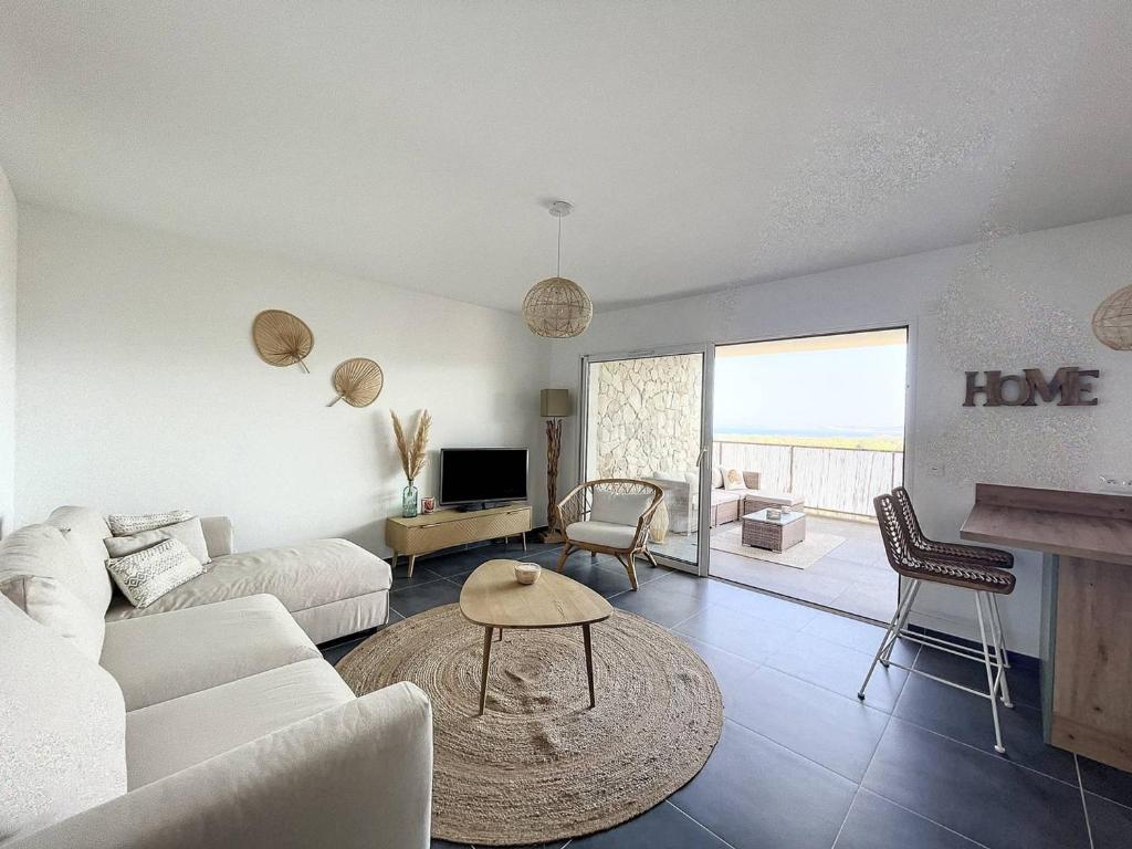 a living room with a couch and a table at Appartement Calvi, 2 pièces, 4 personnes - FR-1-719-13 in Calvi