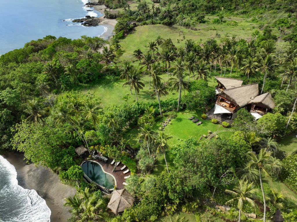 an aerial view of a resort on a tropical island at The Cove Bali by Nakula in Balian