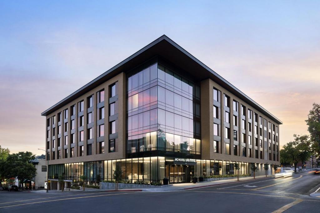 an office building with glass windows on a street at AC Hotel by Marriott San Rafael in San Rafael