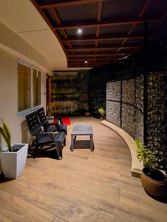 a living room with two chairs and a table at Kuruva Island Resort And Spa - By KABINI BREEZE, Wayanad in Mananthavady