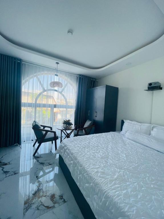 um quarto com uma cama, uma secretária e uma janela em T~ONE HOSTEL em Cái Răng