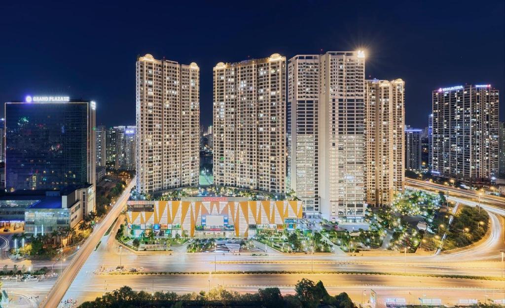 a city skyline at night with tall buildings at Dcapitale - Feria Homes in Hanoi