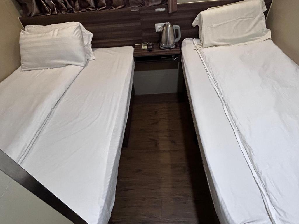 Postel nebo postele na pokoji v ubytování 香港名都商务旅馆 Ming Du Guesthouse