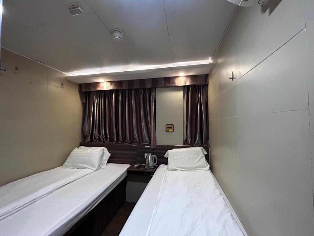 Postel nebo postele na pokoji v ubytování 香港名都商务旅馆 Ming Du Guesthouse