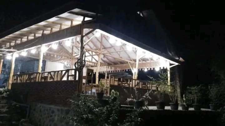 a house lit up at night with lights on it at Orchid Bugalows. in Timbanglawang