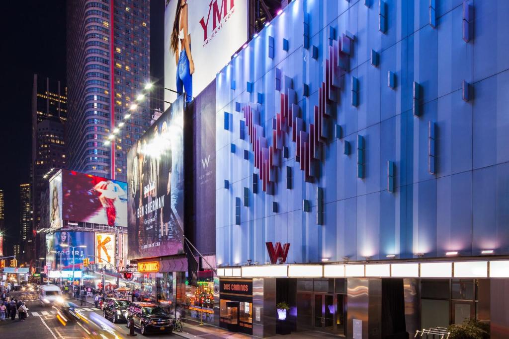 a city street at night with traffic and buildings at W New York - Times Square in New York