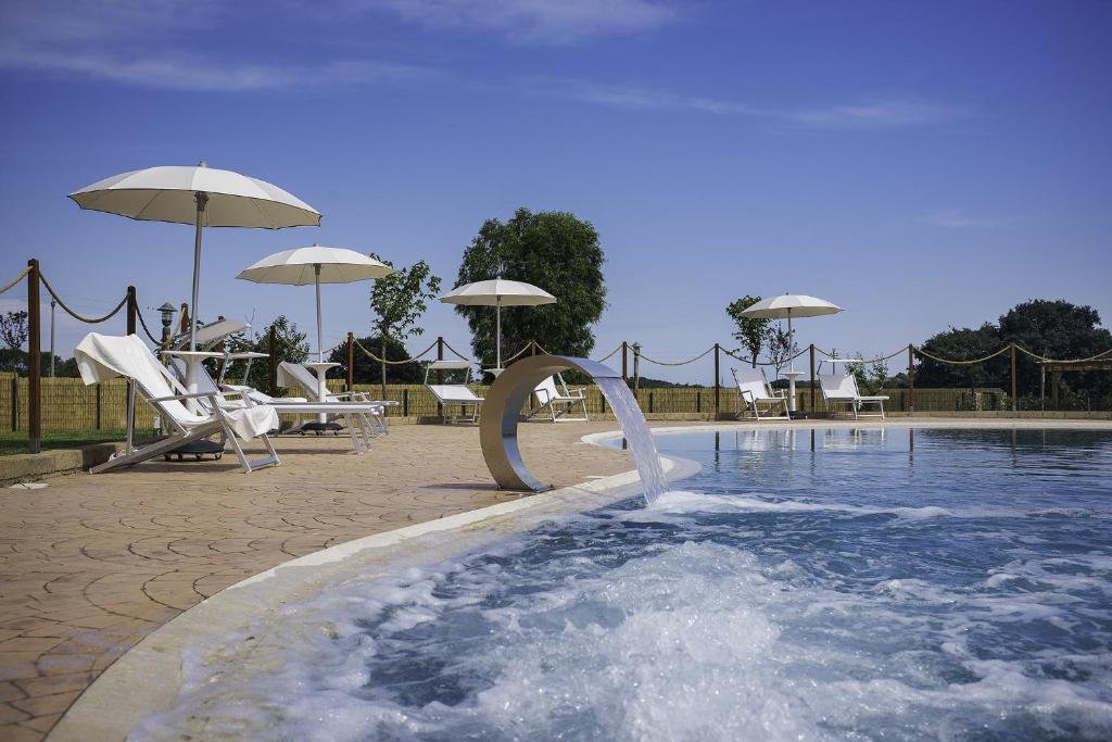 a pool with a water slide in the middle at Cascina al Colle in Populonia