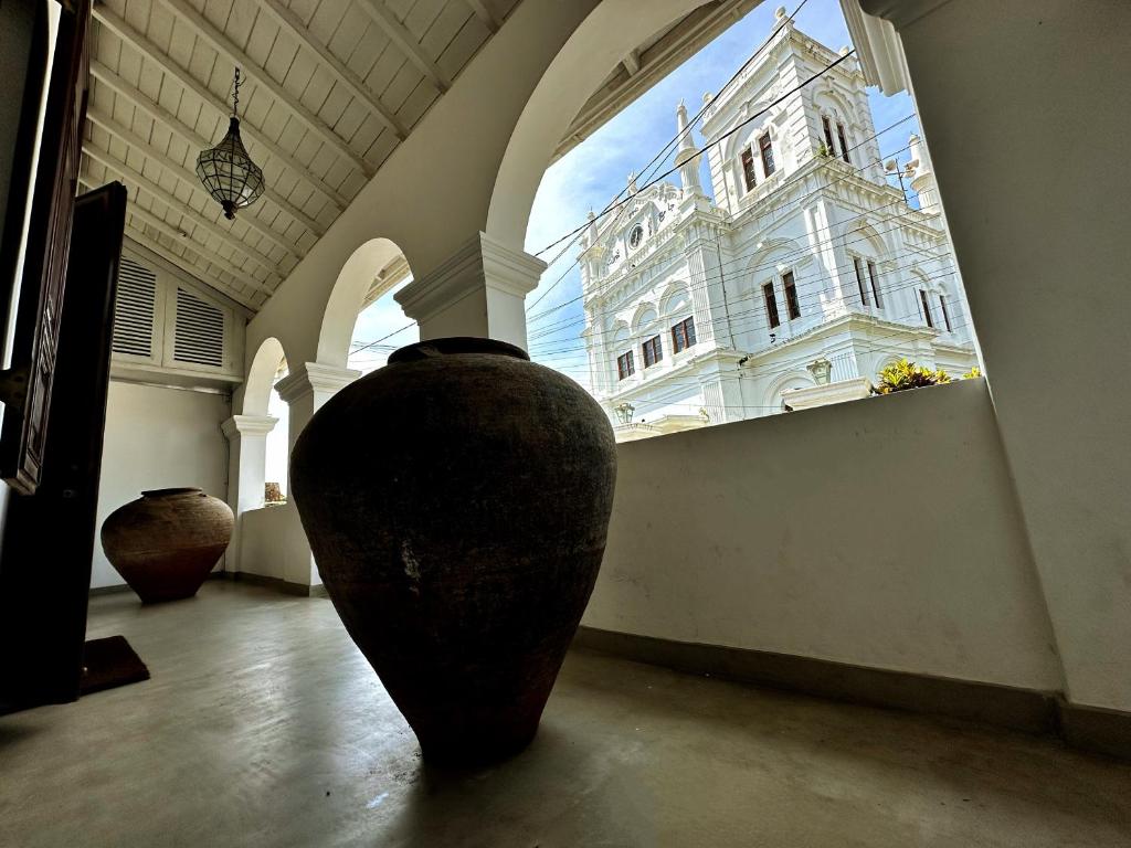 a large vase in a room with a large building at 89 Leyn Baan by AQUA Villa in Galle