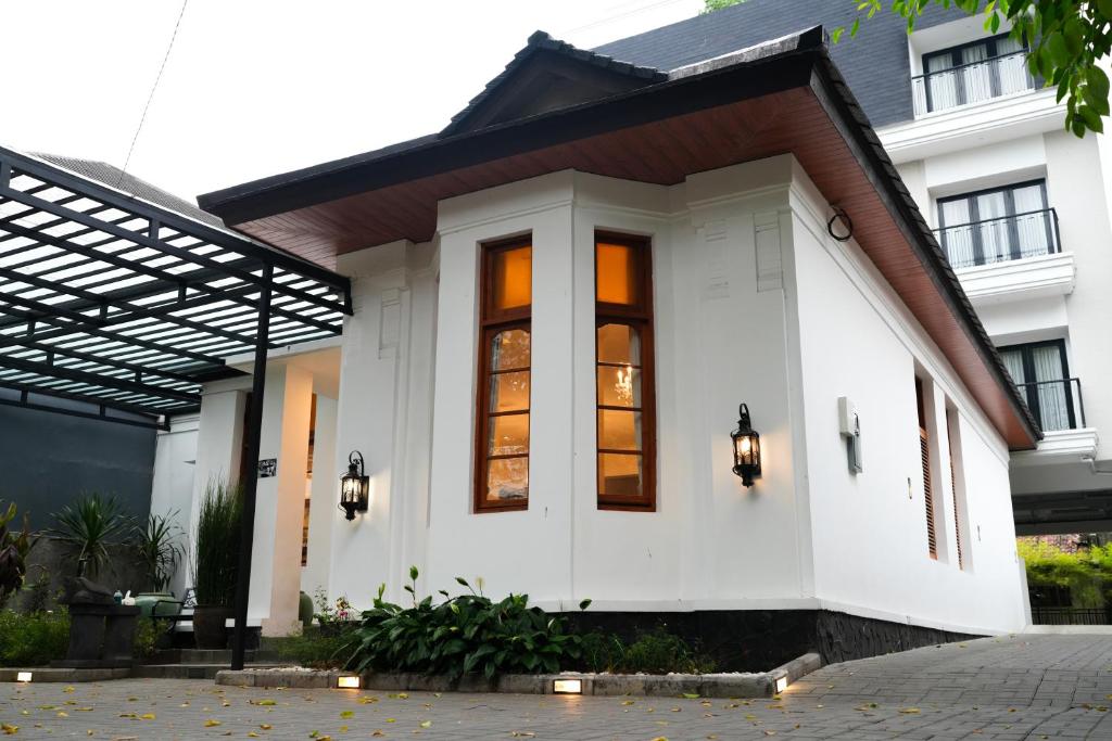 a white house with a black roof at BUMINAKURA in Bandung