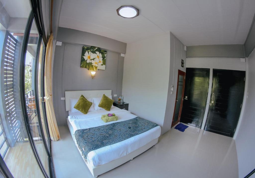 プラナコーン・シー・アユタヤにあるCasa Krung Kaoのベッドルーム(緑の枕が付く白いベッド付)
