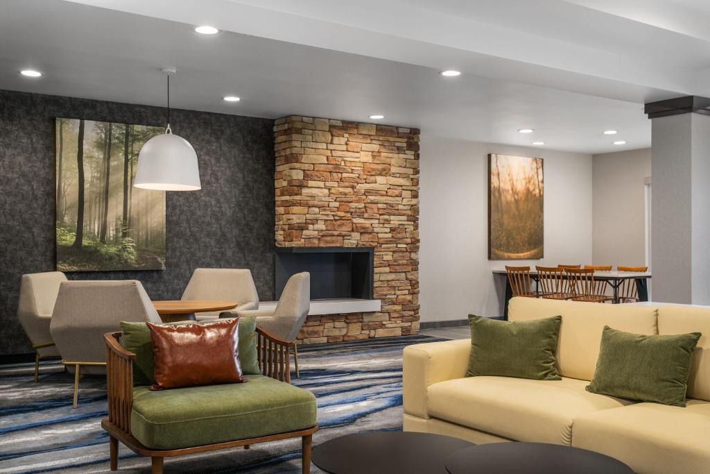 a living room with a couch and a fireplace at Fairfield Inn & Suites by Marriott Chattanooga South East Ridge in Chattanooga