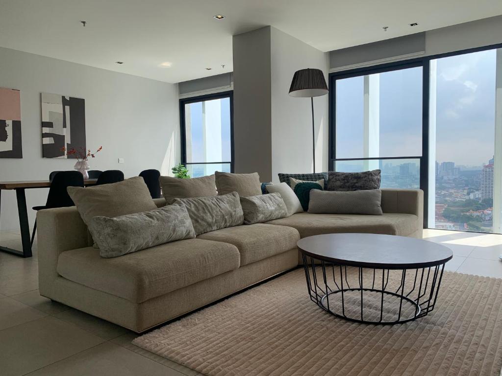 a living room with a couch and a table at 3 Bedroom Condominium in LUMI TROPICANA in Petaling Jaya