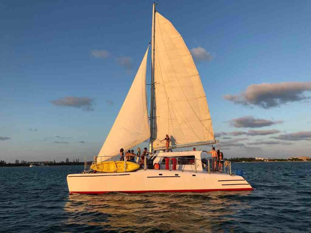 a group of people on a sailboat on the water at Mariah Catamaran in Miami Beach