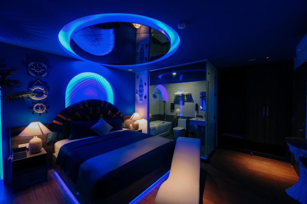 a blue bedroom with a bed and a bathroom at Chiic House 5 - Khách sạn tình yêu in Nha Trang