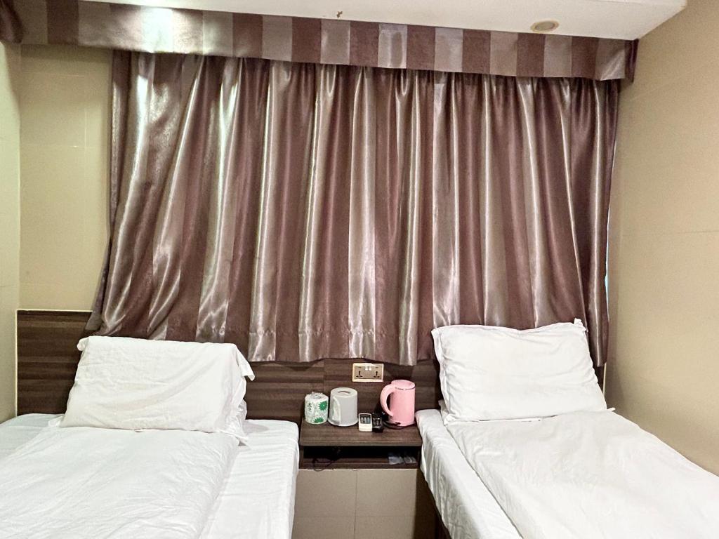 Postel nebo postele na pokoji v ubytování 香港星星旅馆 2202 Guesthouse