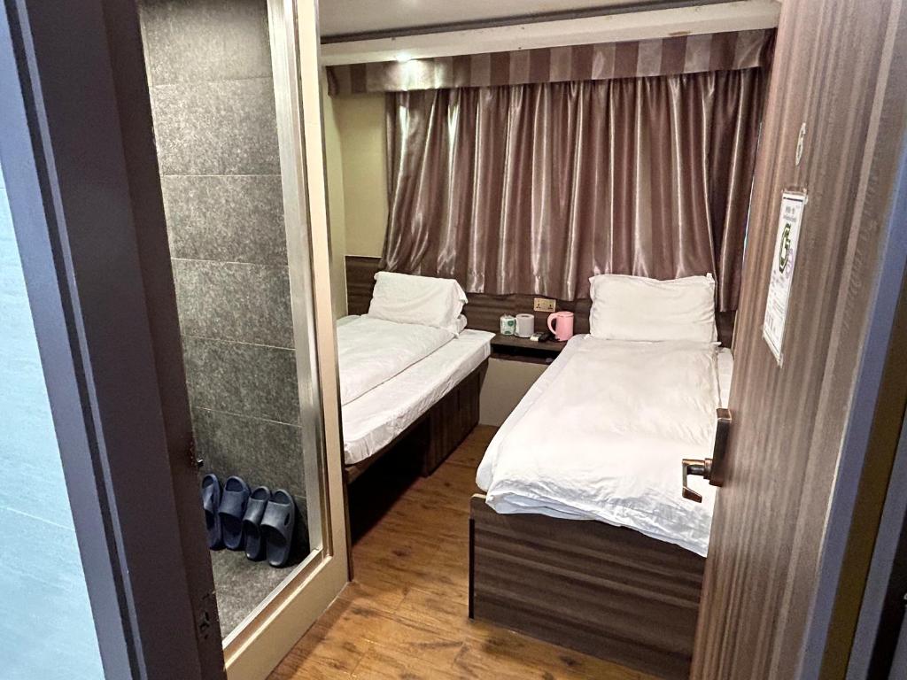 Postel nebo postele na pokoji v ubytování 香港星星旅馆 2202 Guesthouse