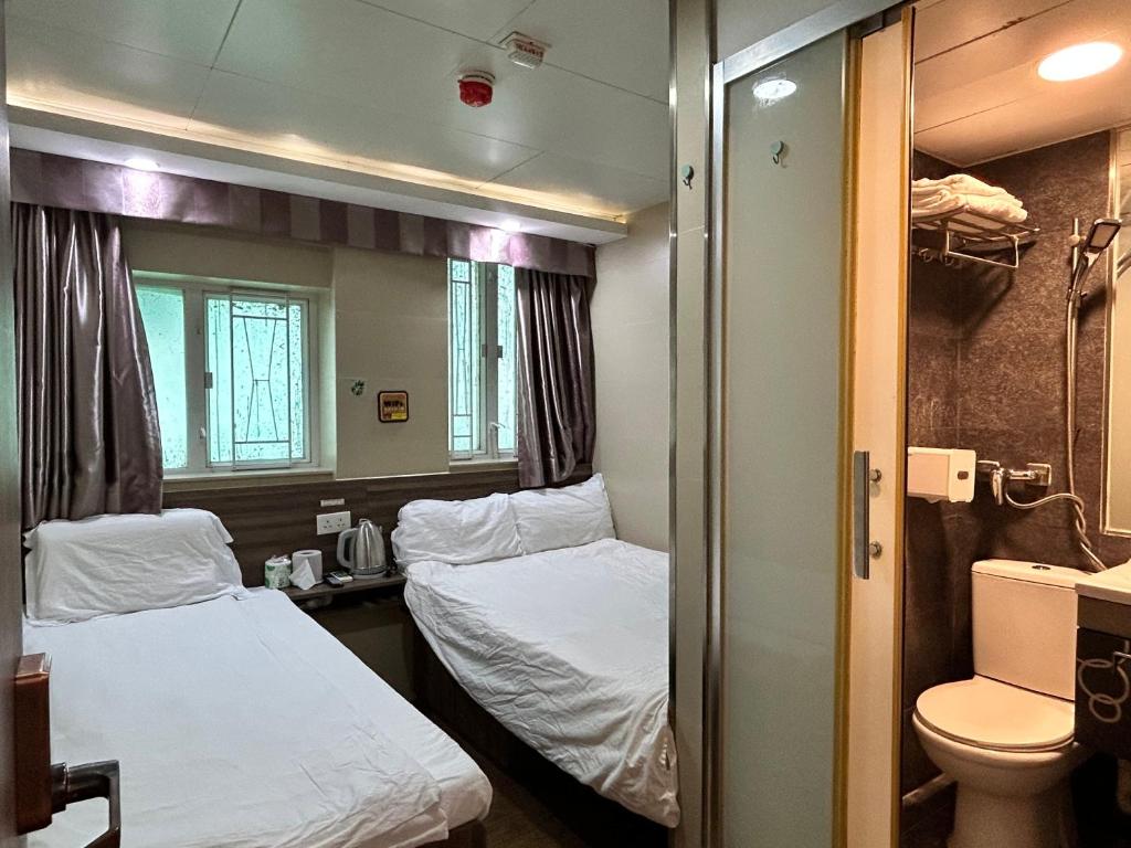 Postel nebo postele na pokoji v ubytování 香港星星旅馆 2202 Guesthouse