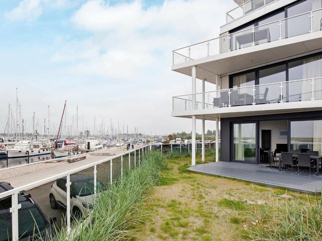 a large white building with a marina at Two-Bedroom Holiday home in Wendtorf 29 in Wendtorf