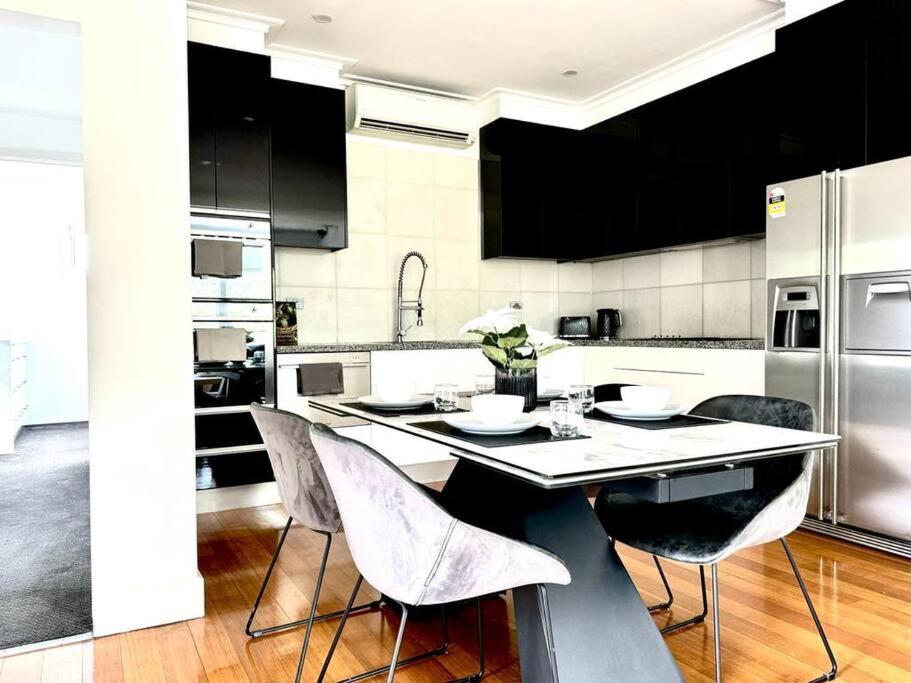 a kitchen with a table and chairs in it at Luxury stay in Williamstown in Williamstown