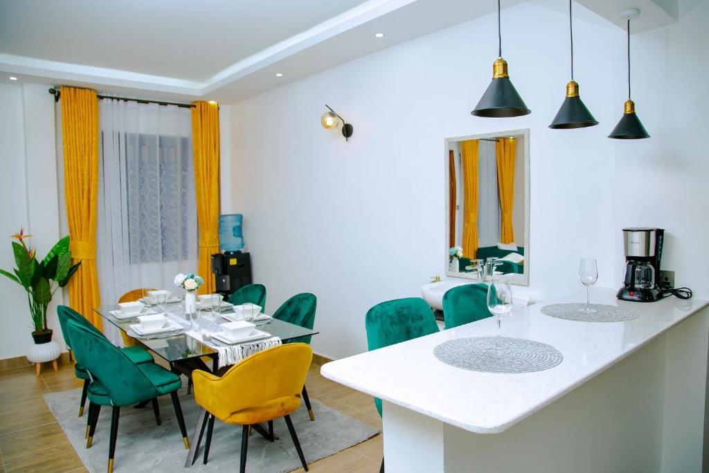 a kitchen and dining room with a table and chairs at Zuriama Residency in Kisumu