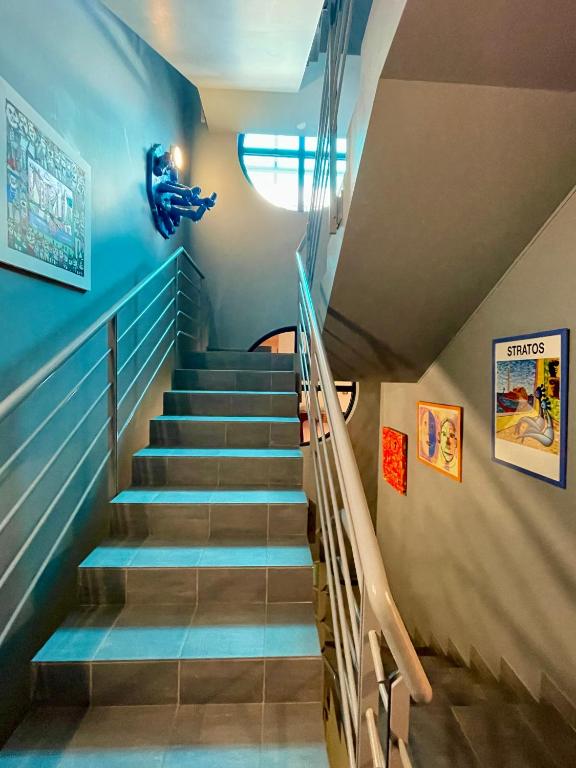a staircase in a building with blue walls at Domus Hotel in Luxembourg