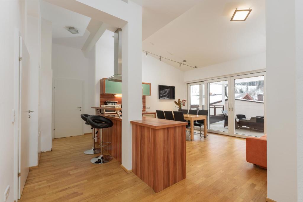 a living room with a desk and a dining room at Ferienwohnungen Karoline by Schladming-Appartements in Schladming