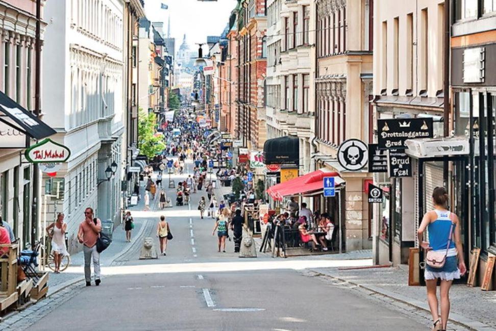 a group of people walking down a city street at Stockholm City in Stockholm