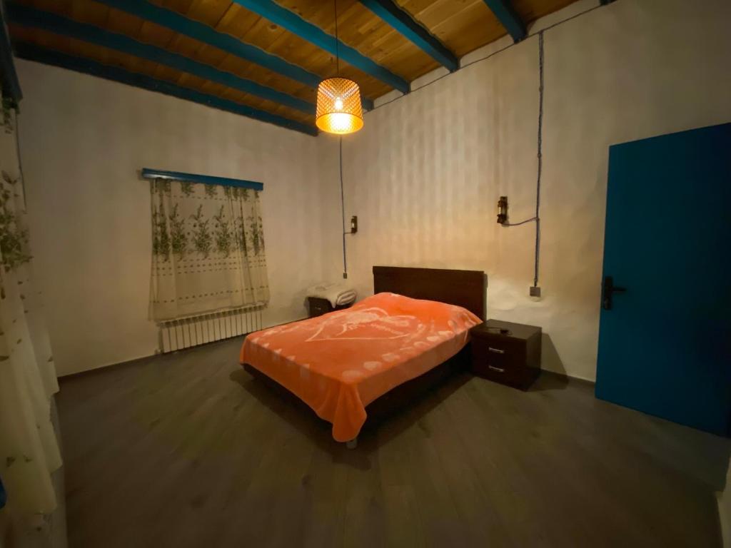 a bedroom with an orange bed in a room at İvanovka Butik House in İvanovka