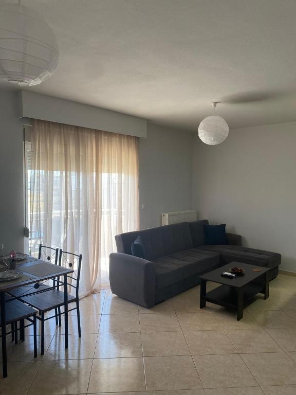 a living room with a couch and a table at Luxury Apartment 2 in Alexandroupoli