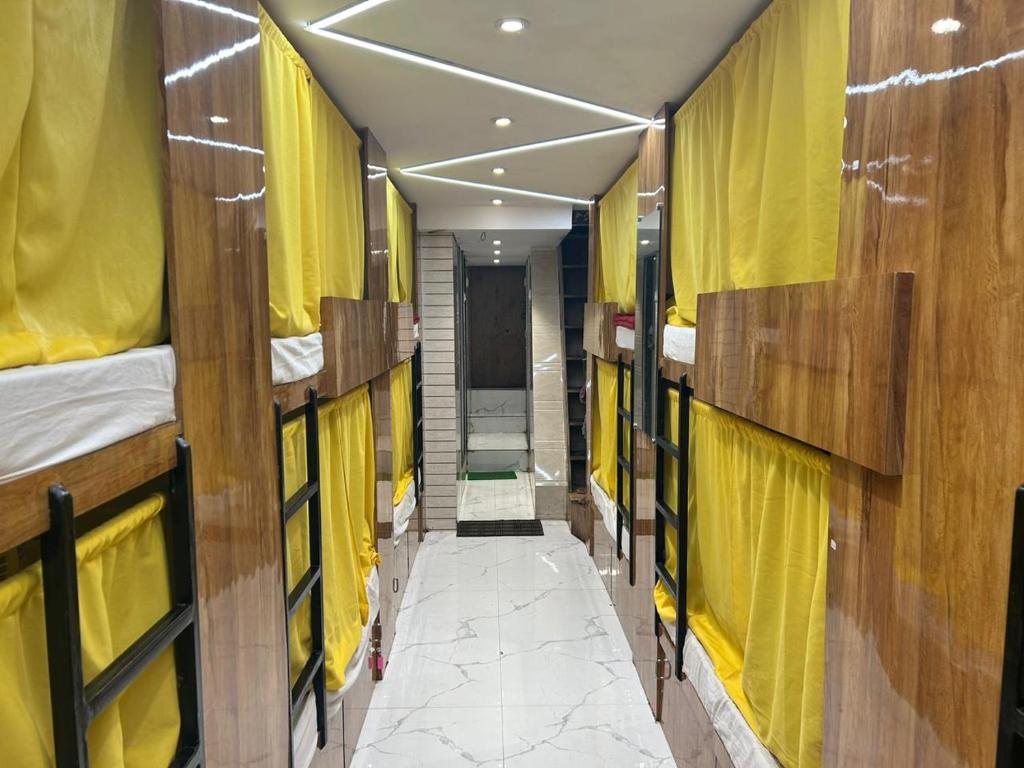 a corridor of a dorm room with bunk beds at Sai Sharan Dormitory-Near Dadar Railway Station in Mumbai