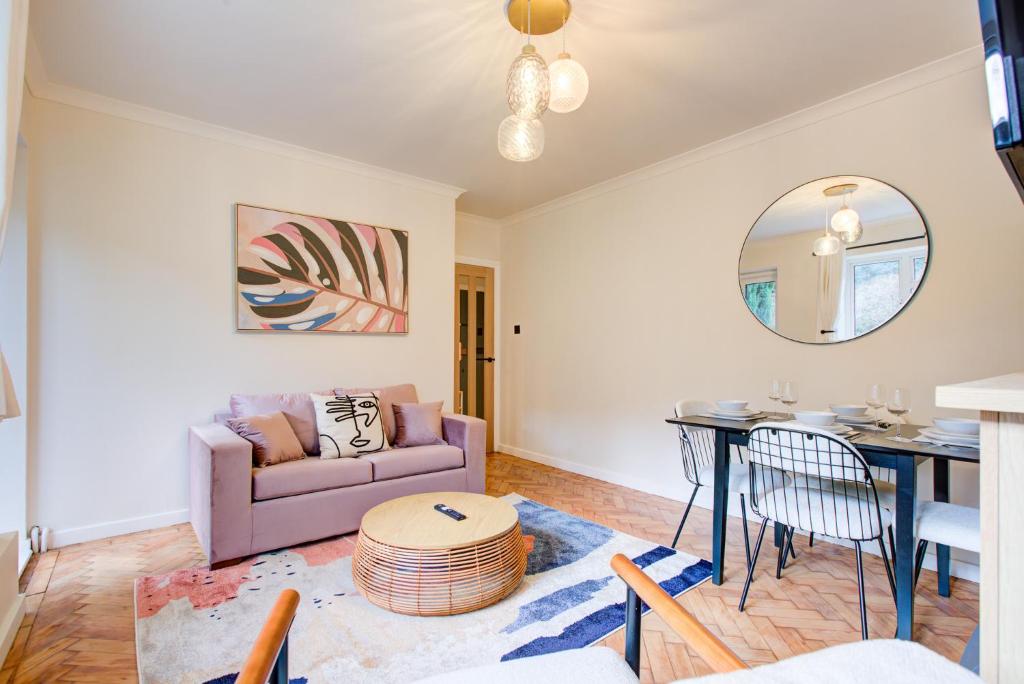 a living room with a couch and a table at Artsy Serviced Apartments - Highgate in London