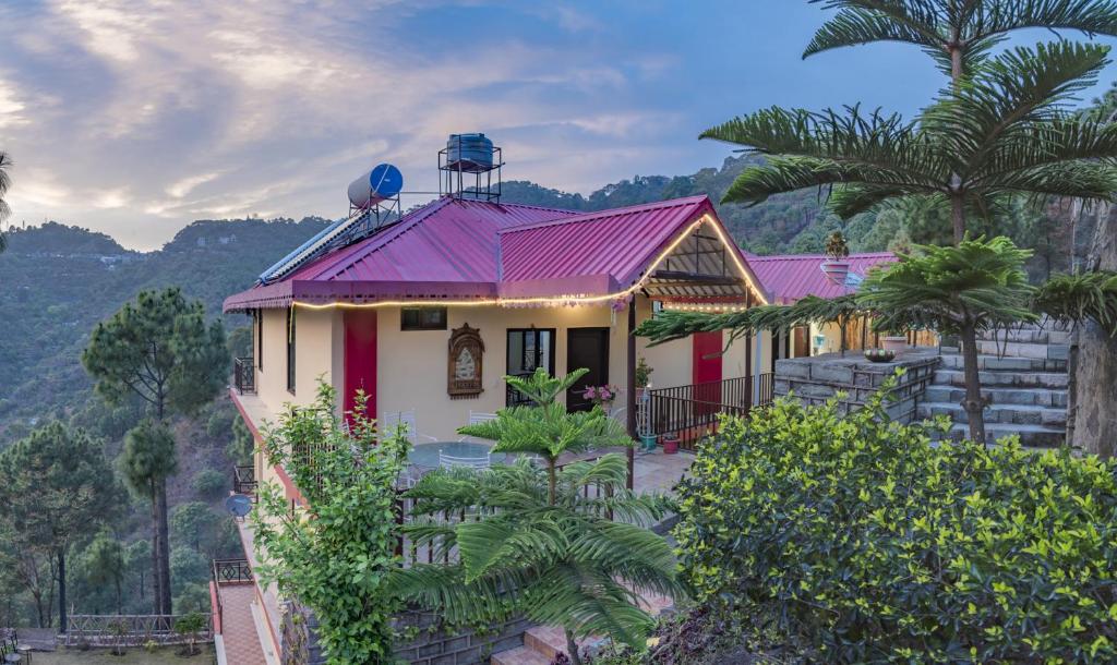 a house with a purple roof with palm trees at Rudra Hotel And Resort ! New ! Mountain ! Kasauli in Kasauli
