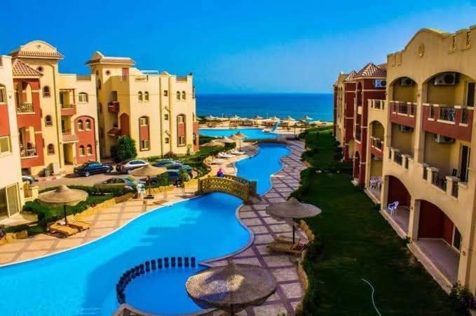 an aerial view of a resort with pools and umbrellas at فيلا دوبلكس في لاسيرينا السخنة in Ain Sokhna