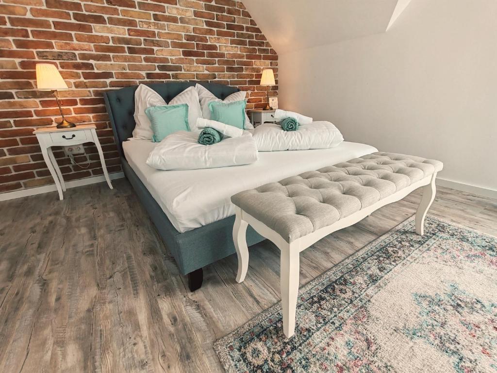 a bedroom with a bed and a brick wall at Elisoria Superiors in Cserszegtomaj