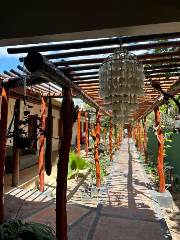 a covered walkway with orange and white decorations at Imperio dos Bambus Suites in Jijoca de Jericoacoara