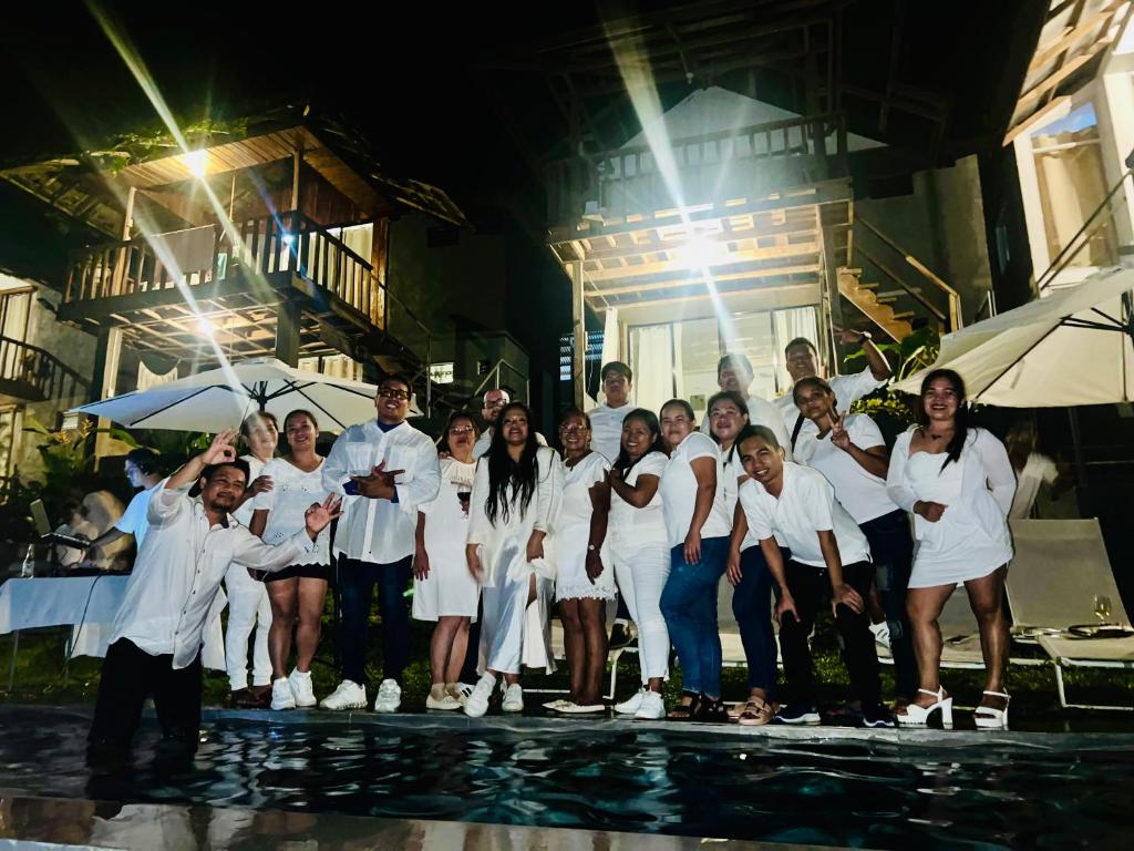 a group of people in white posing for a picture at Bintana sa Paraiso Binunsaran in Mambajao