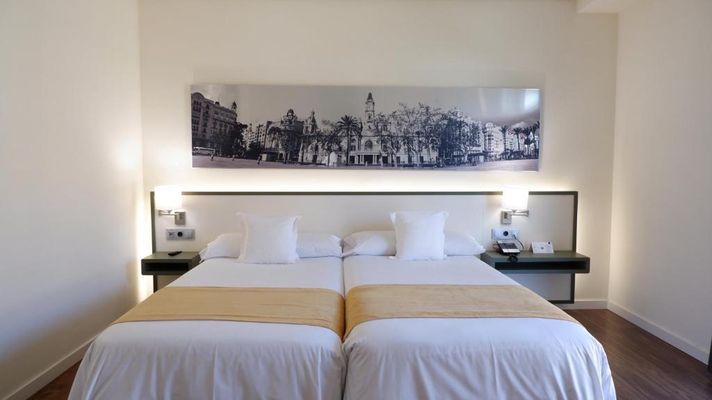 A bed or beds in a room at Primus Valencia