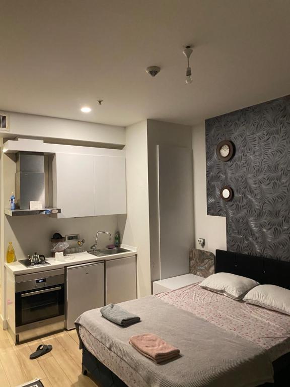 a small bedroom with a bed and a kitchen at MANZARA in Istanbul